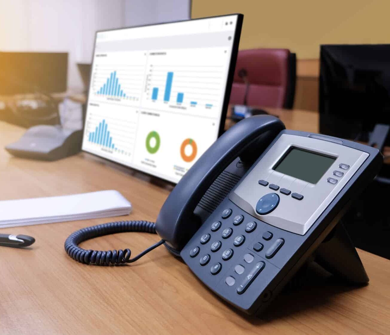 desk with computer pen phone and notepad